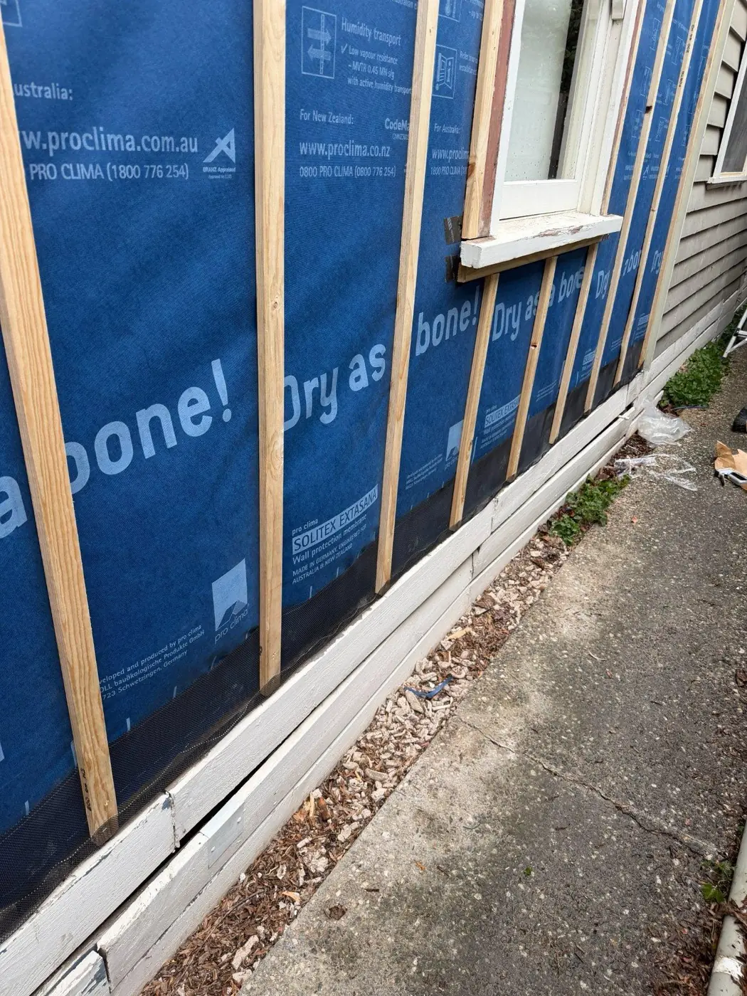 Cavity battens installed over the membrane before recladding.