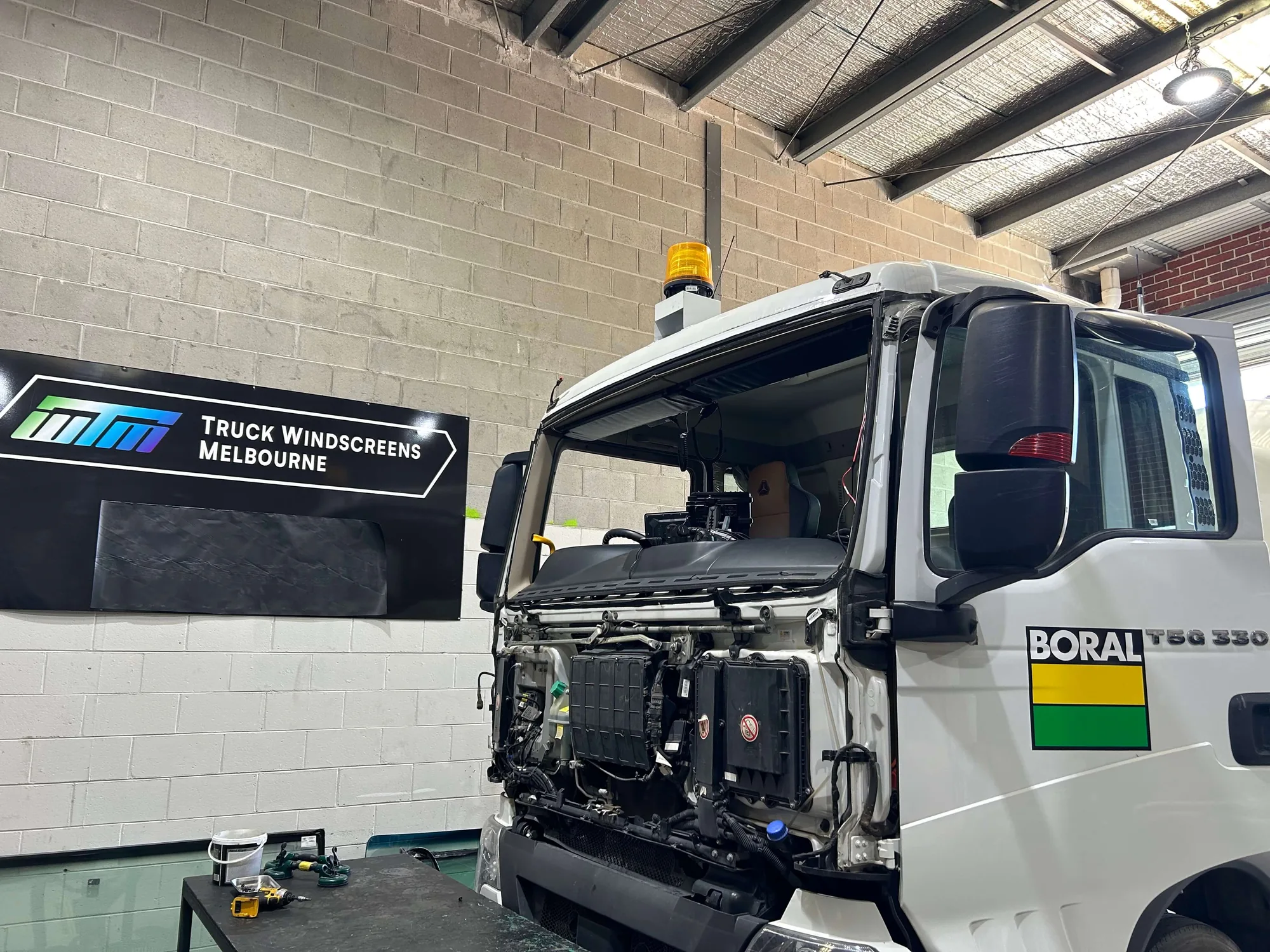 A Boral truck in the workshop with the windscreen removed and the aperture prepped