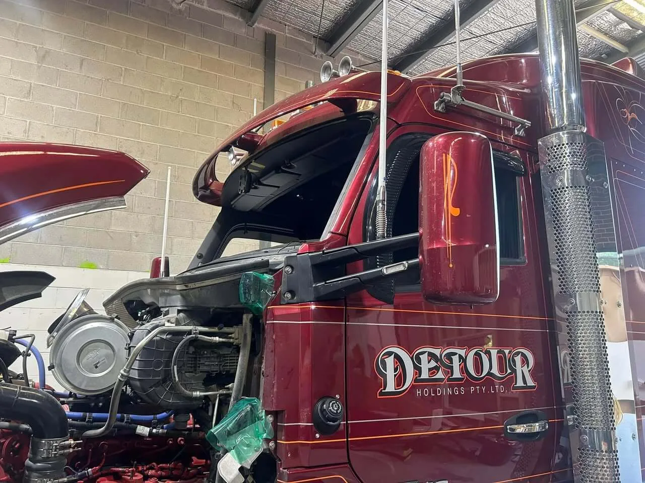 A Kenworth prime mover in the Truck Windscreens Melbourne workshop with its windscreen out