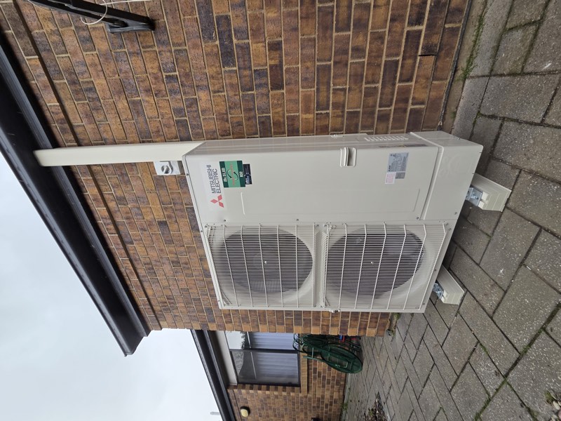 Mitsubishi Electric outdoor unit installed on brick wall