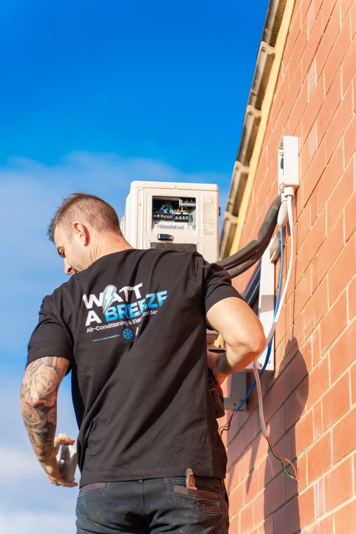 Watt A Breeze technician installing an air conditioning outdoor unit